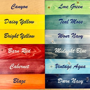 May include: A wood sample board with 12 different wood stain colors. The colors are Canyon, Lime Green, Daisy Yellow, Teal Moss, Bright Yellow, Worn Navy, Barn Red, Midnight Blue, Cabernet, Vintage Aqua, Blaze, and Darn Navy.