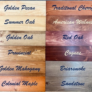 May include: Wood stain color chart with 12 different wood stain colors. The colors are: Golden Pecan, Summer Oak, Golden Oak, Provincial, Golden Mahogany, Colonial Maple, Traditional Cherry, American Walnut, Red Oak, Cognac, Briarsmoke, and Sandstone.