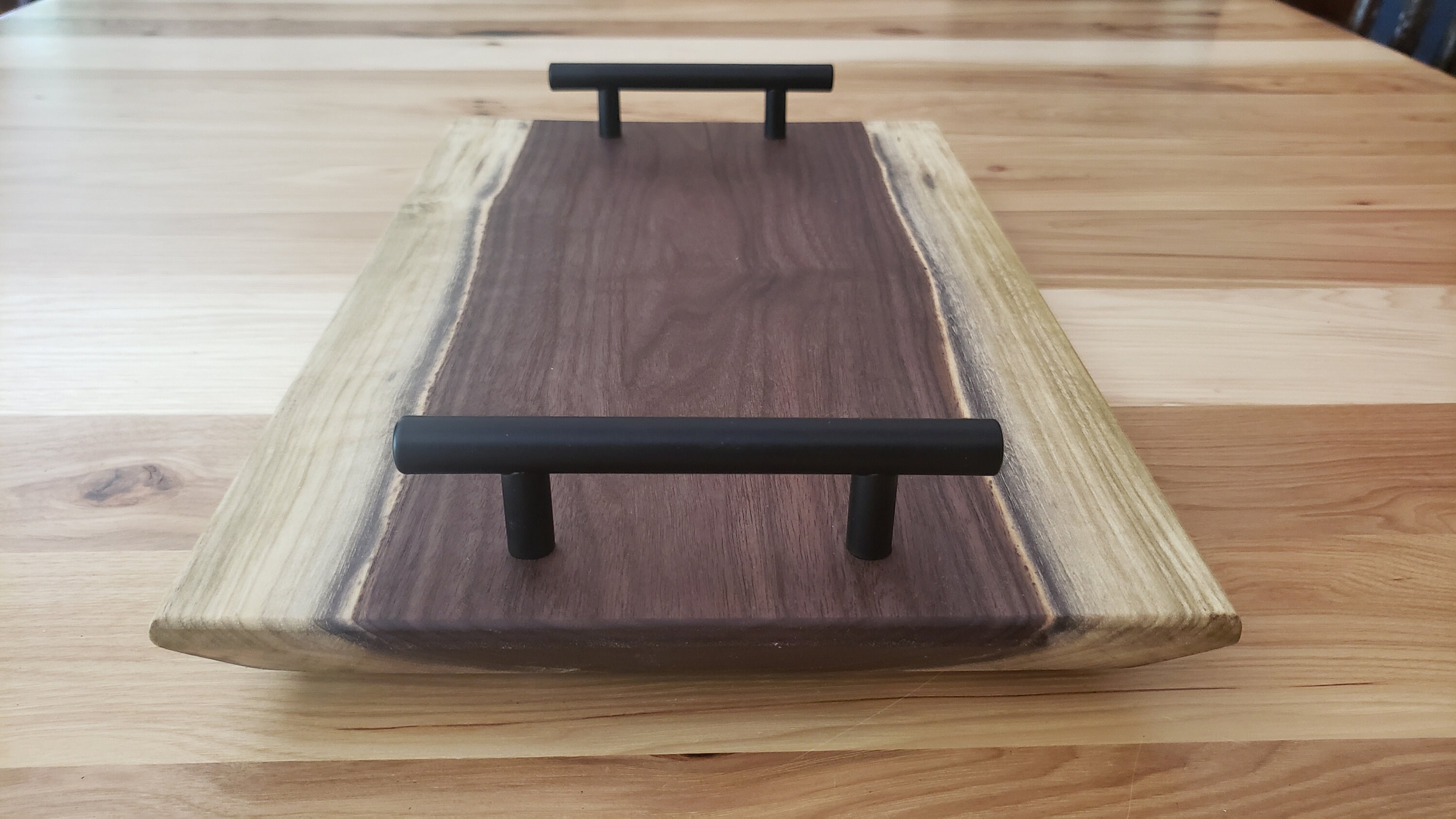 Charcuterie board with black stainless steel handles featuring Etsy