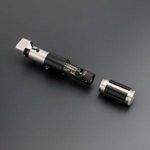 May include: A disassembled lightsaber prop with a black and silver handle. The handle is partially open, revealing the battery compartment with a 2400mAh battery. The detached end cap is also silver and black.