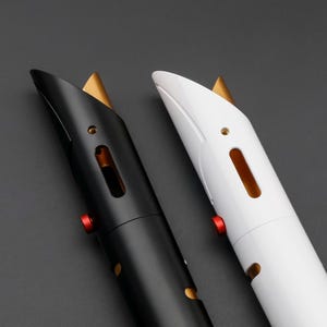 May include: Two futuristic-looking lightsabers, one black and one white, are displayed against a dark gray background. Each saber features a gold accent at the top, a red button, and a sleek, modern design. The sabers have a metallic appearance.