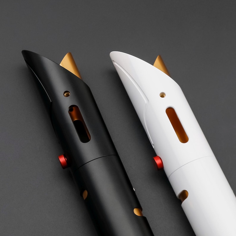 May include: Two futuristic-looking lightsabers, one black and one white, are displayed against a dark gray background. Each saber features a gold accent at the top, a red button, and a sleek, modern design. The sabers have a metallic appearance.