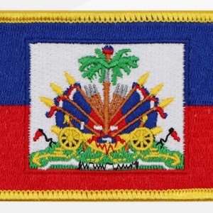 May include: A blue and red embroidered patch with the coat of arms of Haiti. The coat of arms features a palm tree, cannons, and flags.