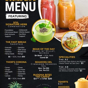 May include: A colorful menu for The Bean's & Juice Cafe featuring smoothies, bowls, and other healthy food options. The menu includes a variety of ingredients, including avocado, banana, spirulina, hemp seeds, mango, and more. The cafe also offers a selection of teas, including Thor's Corona Tea, and a variety of specialities, including the A2 and the AB. The menu also features a selection of t-shirts and hoodies.