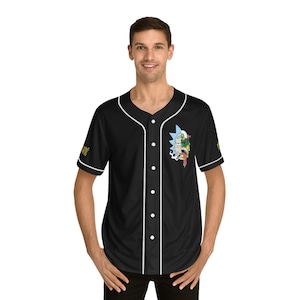 May include: Black baseball jersey with white trim and a cartoon character graphic on the front. The character has a green and blue face with a red tongue sticking out.