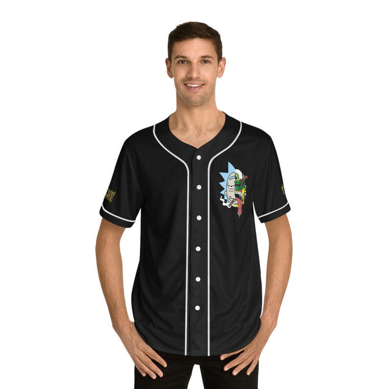 May include: Black baseball jersey with white trim and a cartoon character graphic on the front. The character has a green and blue face with a red tongue sticking out.