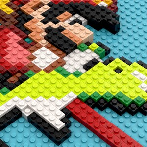 May include: A close-up of a green, yellow, and white Lego figure of a dinosaur, partially obscured by a red, brown, and black Lego figure of a person.