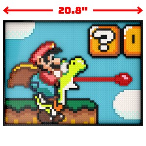 May include: A framed pixel art picture of a video game character, Mario, riding a dinosaur-like creature. The picture is 20.8 inches wide and 15.7 inches tall. The background is blue with a question mark block and a coin block.