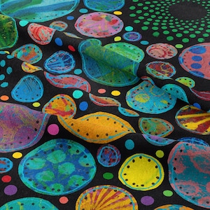 May include: A black fabric with a colorful, abstract pattern. The design features various shapes, including circles and organic forms, in shades of blue, green, yellow, pink, and purple. The fabric has a textured appearance.