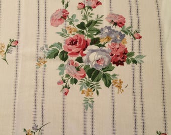 May include: A white fabric with a repeating pattern of vertical stripes and pink, purple, and yellow floral bouquets. The stripes are a light gray color.