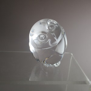 May include: A clear glass owl figurine with detailed features. The owl is perched on a clear glass base.