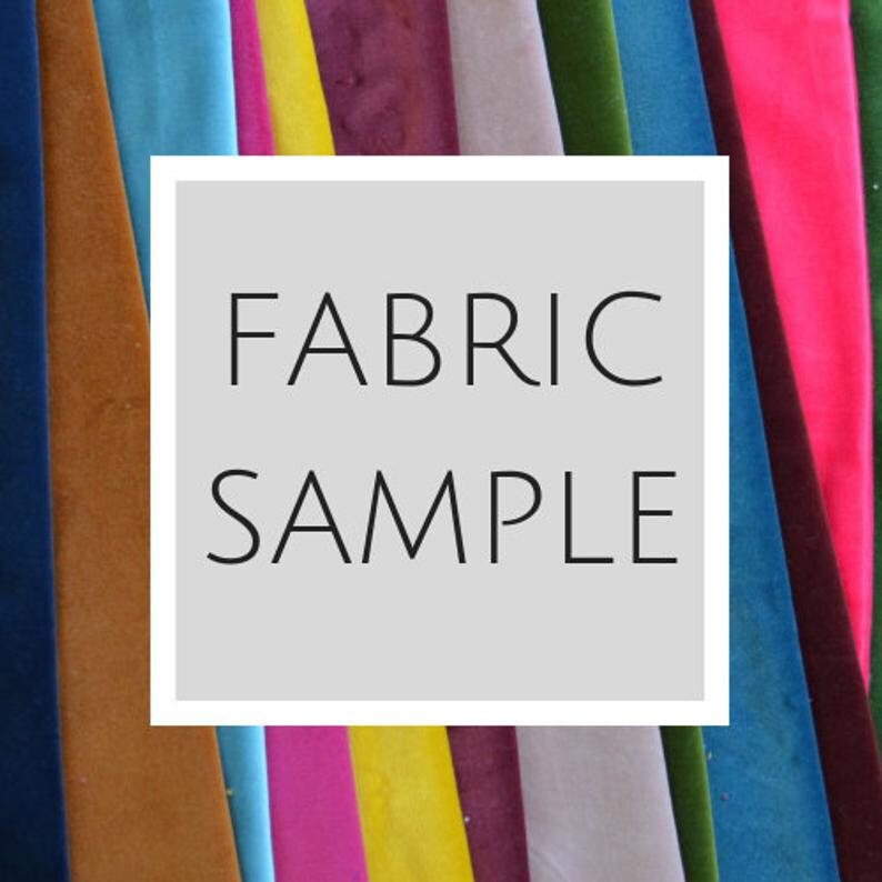 May include: A variety of fabric swatches in different colors, including blue, green, yellow, pink, and brown. The swatches are arranged in a row and have the text "FABRIC SAMPLE" written on a white rectangle in front of them.