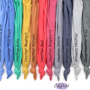May include: A selection of 12 different colored t-shirt fabrics, including ice blue, Columbia blue, true royal, kelly green, mustard, autumn, red, raspberry, storm, navy, athletic heather, deep heather grey, and dark grey heather.