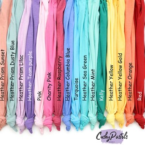 May include: A variety of t-shirt colors, including Heather Prism Mint, Heather Prism Peach, Heather Prism Ice Blue, Heather Prism Sunset, Heather Prism Dusty Blue, Heather Prism Lilac, Heather Team Purple, Pink, Charity Pink, Heather Raspberry, Heather Columbia Blue, Turquoise, Heather Sea Green, Heather Mint, Kelly, Heather Yellow, Heather Yellow Gold, Heather Orange, Red, White, Athletic Heather, and Black. Cushy Pastels.