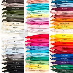 May include: A color chart of 48 different fabric swatches, each with a name label. The swatches are arranged in three columns, with each column representing a different color family. The color families are: warm colors, cool colors, and neutral colors.