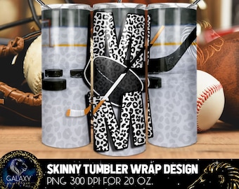 May include: A skinny tumbler wrap design featuring a black and white leopard print letter "M" with hockey sticks and a puck. The design is on a white background with a gold line and a gray and white leopard print background. The design is for a 20 oz. tumbler.