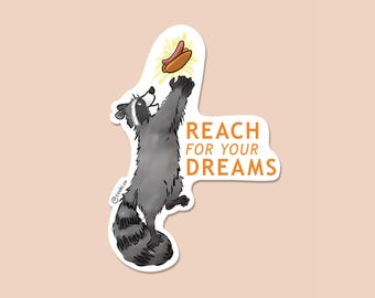 May include: A raccoon reaching up for a hot dog with the text "REACH FOR YOUR DREAMS" in orange letters.