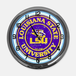 May include: A round wall clock with a black frame. The clock face features the Louisiana State University logo in purple and gold, with the text "LOUISIANA STATE UNIVERSITY" and "EST. 1860". The clock has black hands and white numbers.