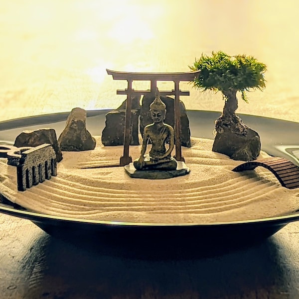 Zen garden for meditation, relaxation & mindfulness training with torii, bridge, wooden rake, Buddha and moss trees - sustainable