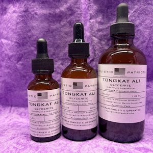 May include: Three glass bottles with droppers containing Tongkat Ali Glycerite. The bottles are labeled with the brand name "Holistic Patriots" and the product name "Tongkat Ali Glycerite". The bottles are in various sizes, with the largest bottle containing 4 fl oz (118 ml).