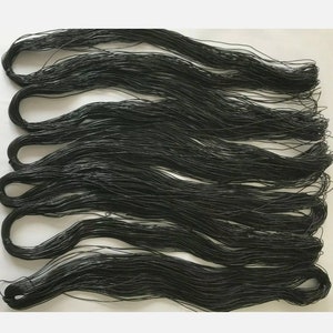 May include: A bundle of black elastic cord, approximately 10 feet long, is coiled and ready for use in crafting projects.