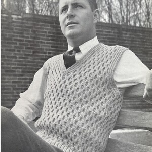 Peut inclure: Un gilet en tricot gris clair à mailles ajourées, avec un col en V, porté sur une chemise blanche à col et une cravate sombre. Le gilet présente un motif texturé. L'image est en noir et blanc.