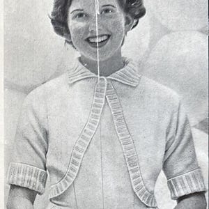 May include: A vintage black and white image of a person smiling, holding a balloon. The person is wearing a light-colored sweater with a collared neckline and a matching skirt. The background features several balloons.