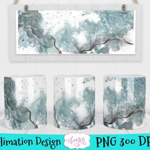 May include: Sublimation design featuring a white mug with a blue and gray abstract watercolor pattern. The design includes a thin black line and silver glitter accents.