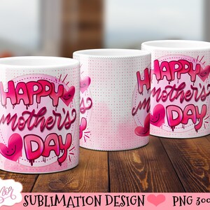 May include: Two white ceramic mugs with pink and white designs. The mugs feature the text "Happy Mother's Day" in a pink, dripping font with pink hearts.