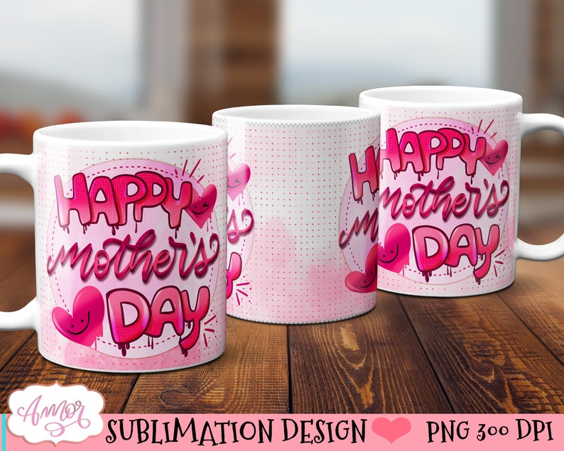 May include: Two white ceramic mugs with pink and white designs. The mugs feature the text "Happy Mother's Day" in a pink, dripping font with pink hearts.