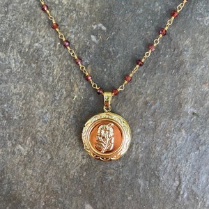 Garnet floral locket gold necklace