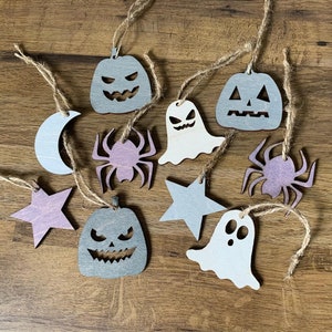 Cute white ghosts crafts, felt sheets, scissors, thread, needles on an old  wooden background. Easy Halloween felt ghosts decor. Halloween sewing  project for kids Stock Photo by ©OnlyZoia 123188402