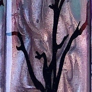 May include: A purple and blue rectangular tile with a black silhouette of a skull with a crow perched on top of it. The skull is surrounded by a black silhouette of a bare tree with branches reaching up.