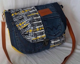 Shoulder bag made from recycled wax-print denim with stripes, yellow jute, and a satchel closure.