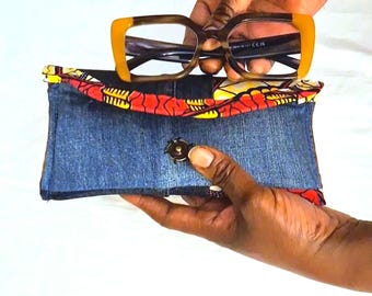 Handmade glasses cases made from recycled jeans and scraps of colorful wax fabric.