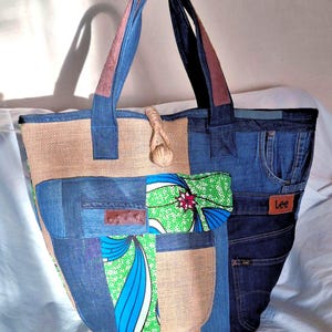 Bag with old jeans, floral wax fabrics and jute, leather handles and hand-woven jute cord