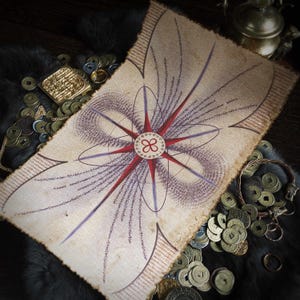 Peut inclure: Un parchemin de style vintage avec un motif de mandala rouge et violet. Le mandala présente une étoile centrale à huit branches avec des lignes rayonnantes et des motifs complexes. Le papier est entouré d'une collection de vieilles pièces de monnaie.
