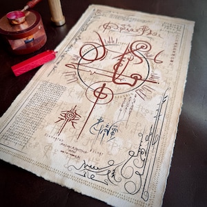 May include: A detailed parchment with brown and black calligraphic symbols and text. The design features a central circular motif and various linear and curved patterns. A red wax seal and a wooden stamp are also visible.