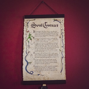 May include: A parchment scroll titled "Soul Contract" with ornate calligraphy and decorative borders in green and blue. The document is suspended from a wooden rod with a black cord. The background is a deep red.