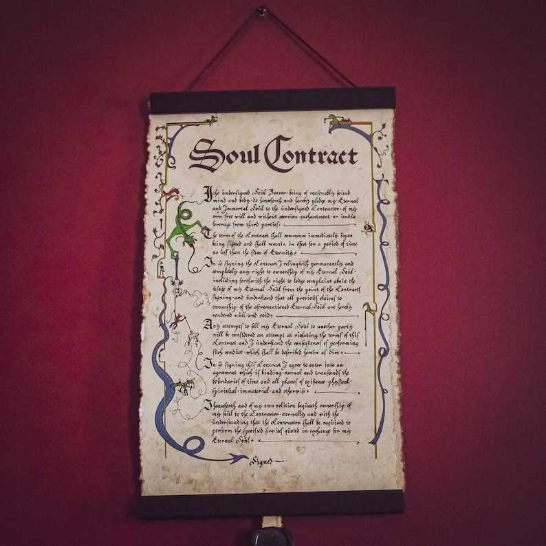 May include: A parchment scroll titled "Soul Contract" with ornate calligraphy and decorative borders in green and blue. The document is suspended from a wooden rod with a black cord. The background is a deep red.