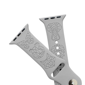 May include: Gray Apple Watch band with geometric animal designs, including an elephant, lion, butterfly, and wolf.
