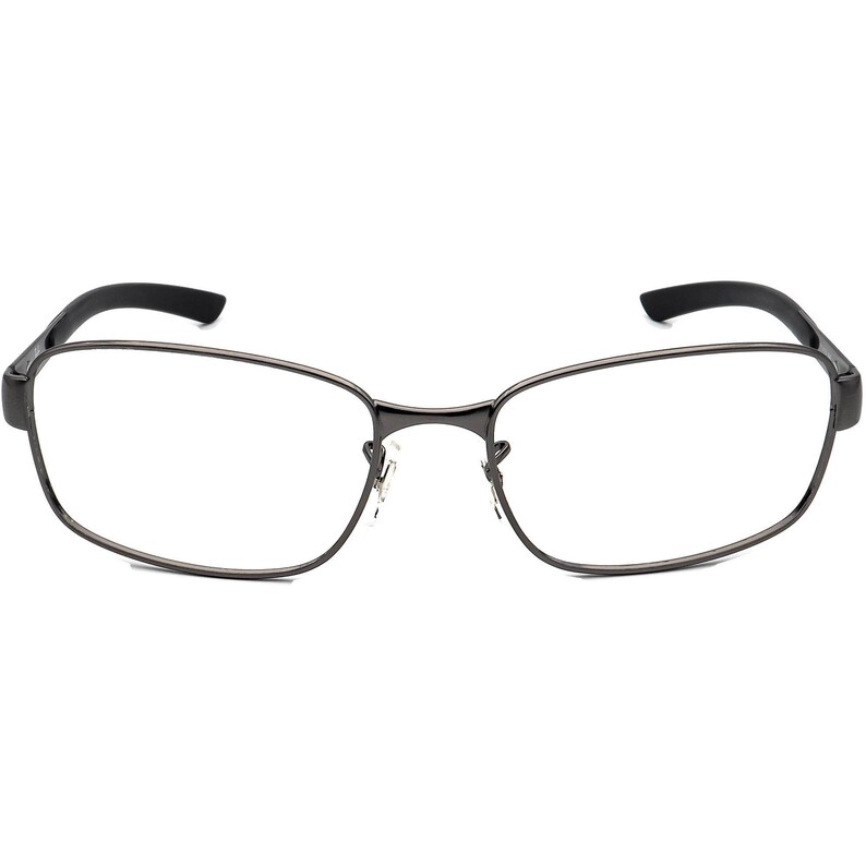 May include: Rectangular spectacles with a dark grey metal frame and black temples. The lenses are clear, and the nose bridge is thin. The spectacles have a modern, minimalist design.