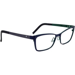 May include: Navy blue eyeglasses with a rectangular frame and a subtle cat-eye shape. The temples have a textured pattern and a small logo. The inner frame is a contrasting green color.