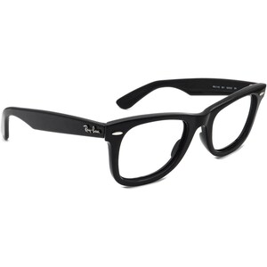 May include: Black plastic framed spectacles with clear lenses. The brand name "Ray-Ban" is printed on the left arm.
