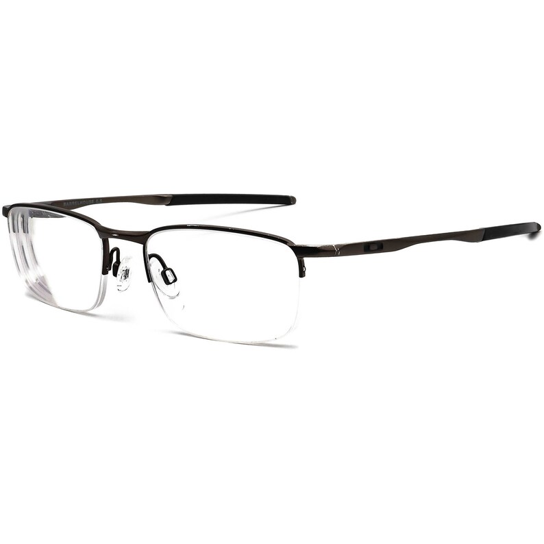 May include: A pair of brown metal frame eyeglasses with clear lenses. The glasses have a thin metal frame and a slightly squared shape.