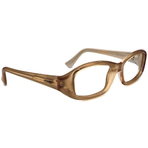 May include: A pair of Fendi eyeglasses with a light brown frame and temples. The lenses are clear, and the Fendi logo is visible on the left temple. The glasses have a rounded, slightly oversized shape.