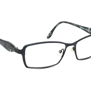 May include: Black rectangular eyeglasses with a green and black patterned frame.