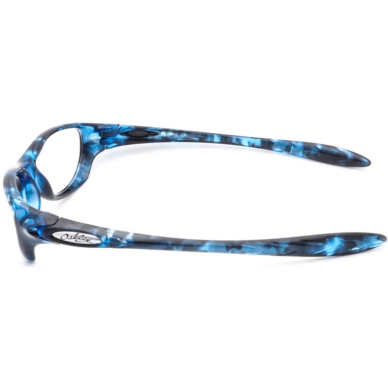 May include: Blue and black patterned Oakley sunglasses with a silver Oakley logo on the side.