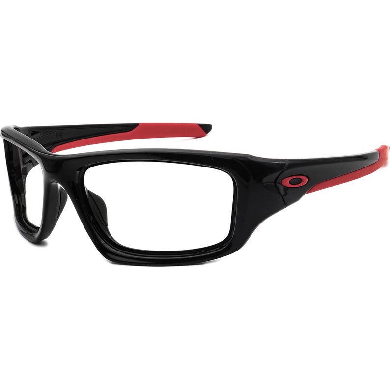 May include: Black and red sports glasses with a clear lens. The glasses have a thick frame and a red accent on the arms.