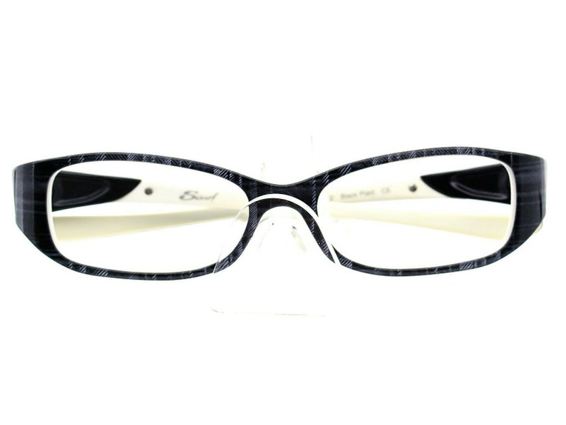 May include: Black and white patterned eyeglasses with a white frame and black arms. The brand name "Eud" is visible on the right arm.